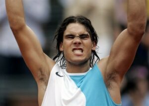 Image of Rafael Nadal with arms raised: spot the difference between this person's left and right arm