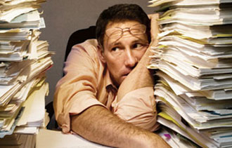 person overwhelmed by papers